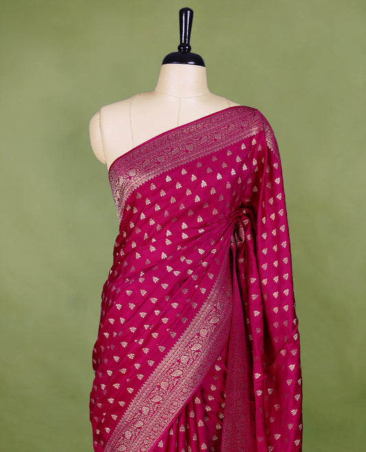 Rani Pink semi-Banaras satin crepe saree featuring traditional closely woven buttas on the body, complemented by an antique-style border and a matching self-coloured blouse.