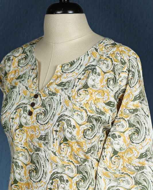 Beige colour kurti with artistic green and mustard swirl print, adorned with wooden buttons along the front placket, featuring a V slit neckline and stylish three quarter sleeves.