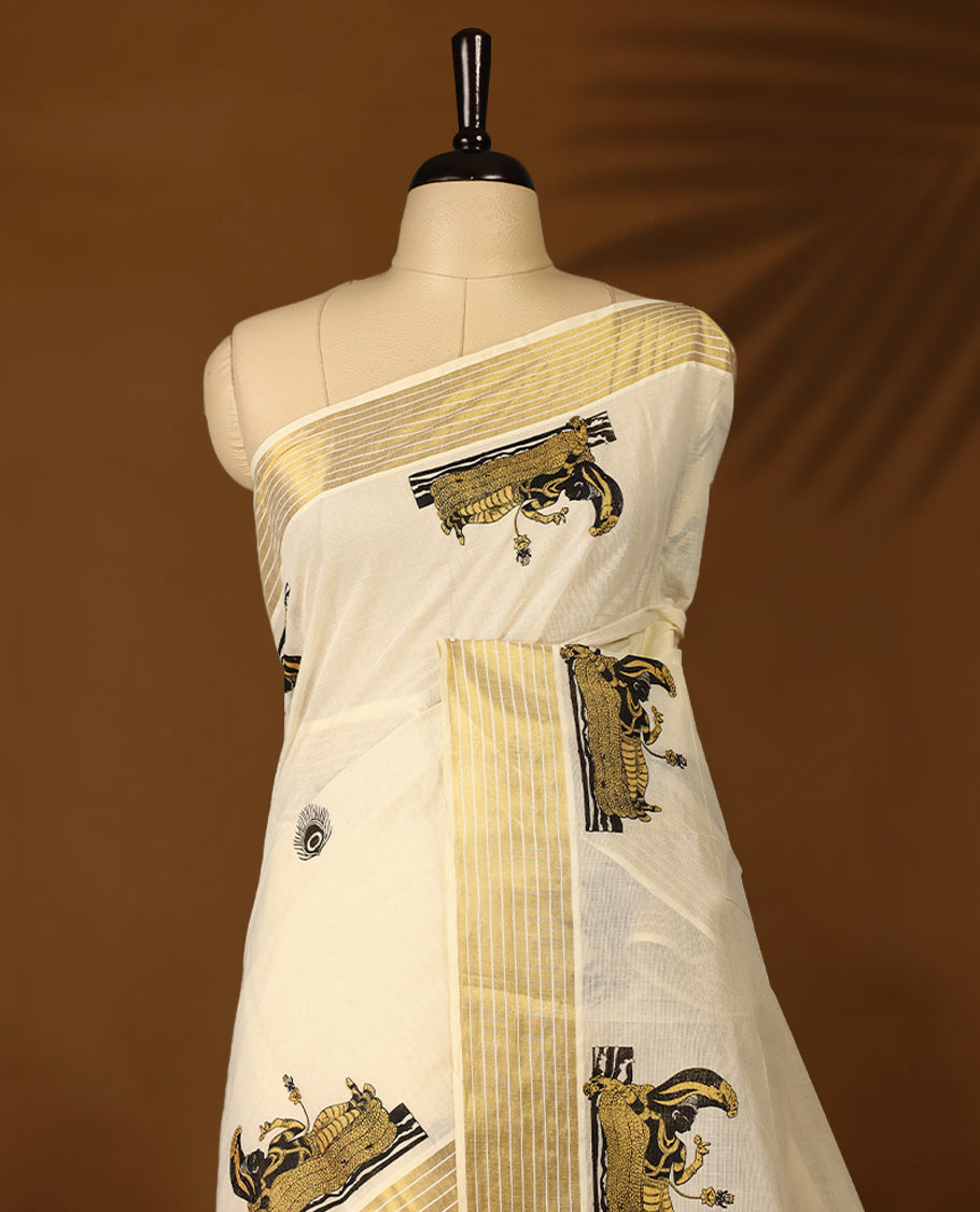 Elegant off white colour cotton Kerala saree featuring peacock feather prints on body, Gold  kasavu border with  Lord Vishnu, offering a classic and graceful look, paired with a matching blouse.