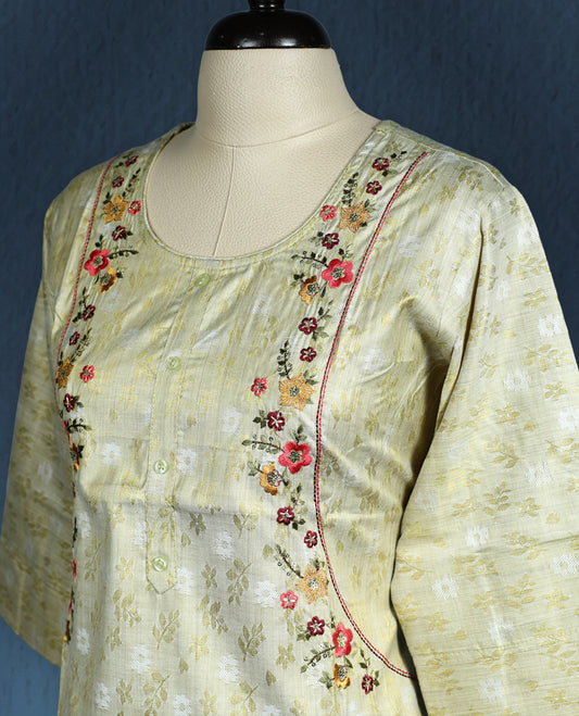 Pistachio green colour kurti with subtle floral self weave, adorned with delicate multicolour floral embroidery along the princess line, featuring a round neckline and stylish three quarter sleeves.