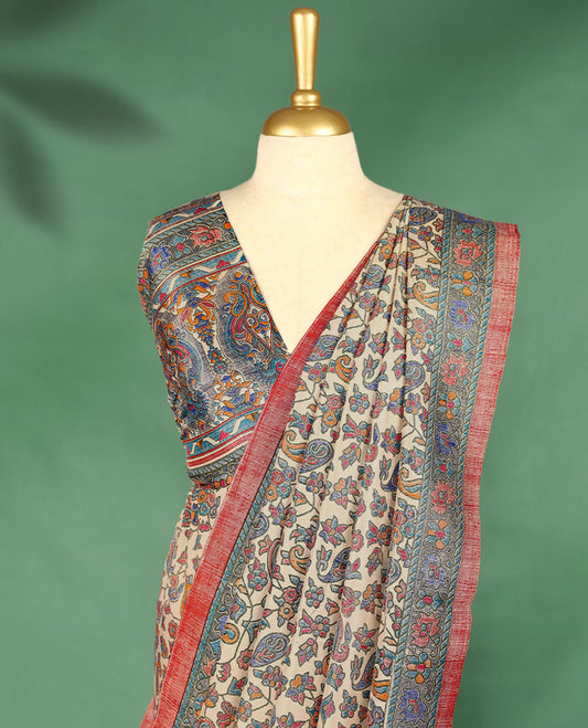 Ivory cream colour Manipuri saree showcases a body adorned with vibrant paisley and floral block motifs, framed by a contrasting blue floral printed border with red piping, and paired with a matching blouse.