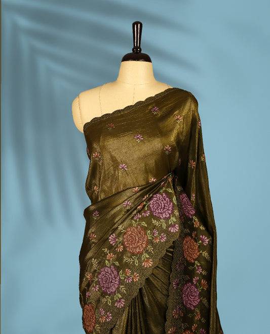 Olive Colour crush soft silk saree, textured body with a natural crinkled finish, adorned with intricate Multi colored floral Motifs and complemented by a delicate Multi Colour Bold Floral embroidery border, paired with a matching blouse