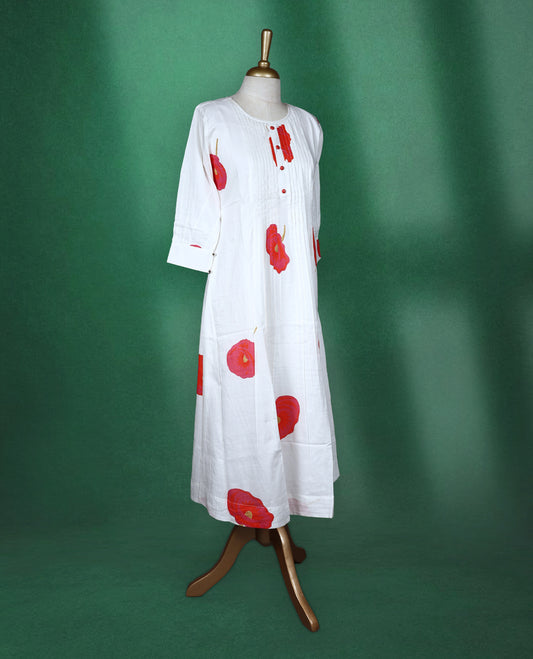 White colour A line kurti featuring a round neck with front pleated detailing, three quarter sleeves, and bold red floral prints for a fresh and elegant look.