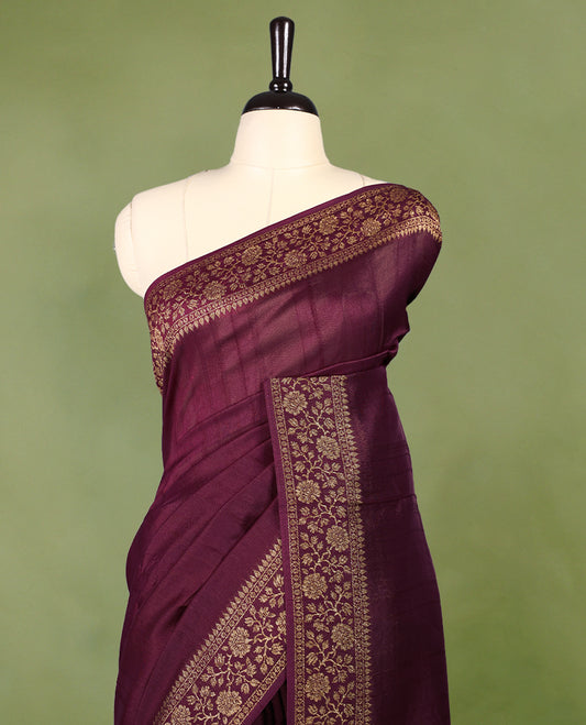 Maroon colour Tussar Banaras saree featuring a plain body, rich floral woven zari border and grand pallu, paired with a matching blouse for an elegant and regal traditional look.
