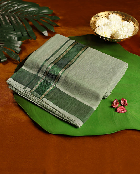 Soft green colour pure handloom double dhoti featuring a rich green kara with subtle golden zari weaving, crafted with fine traditional detailing for elegance, comfort, and cultural occasions.