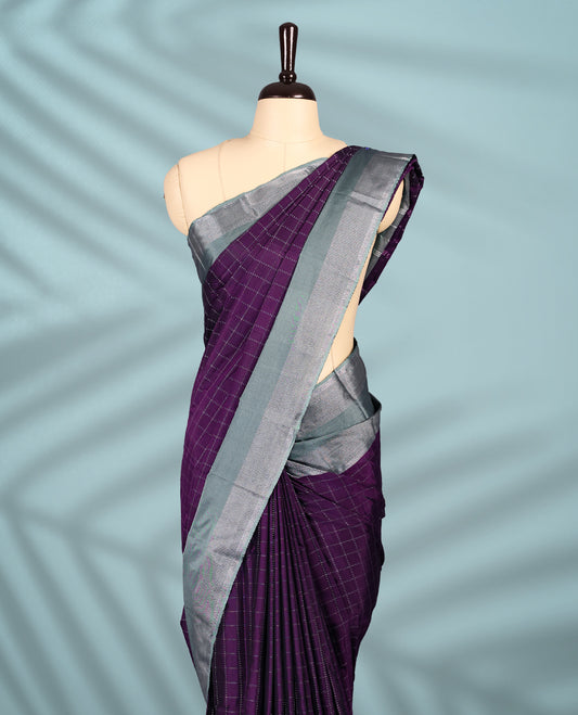 Regal purple Colour semi silk saree showcases a delicate silver zari check pattern, paired beautifully with a contrasting Ash Green border and a matching blouse