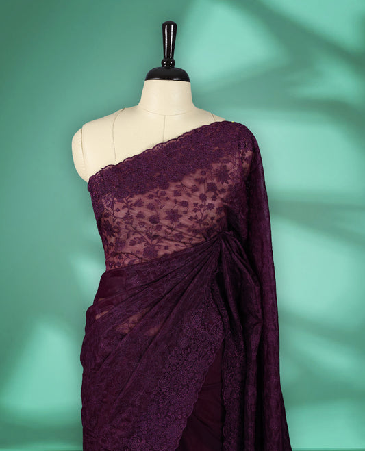Deep Violet colour organza fancy saree adorned with intricate all over embroidery work in floral kodi patterns, finished with a matching floral embroidered border, with matching blouse