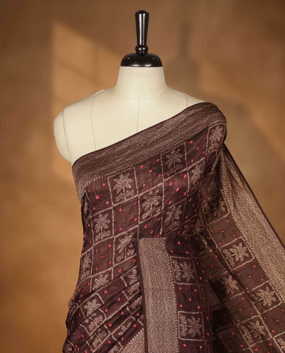 Dark Brown colour Banarasi Bandhani silk saree featuring with intricate Banarasi motifs on body, complemented by antique zari woven border and grand pallu, paired with matching  blouse