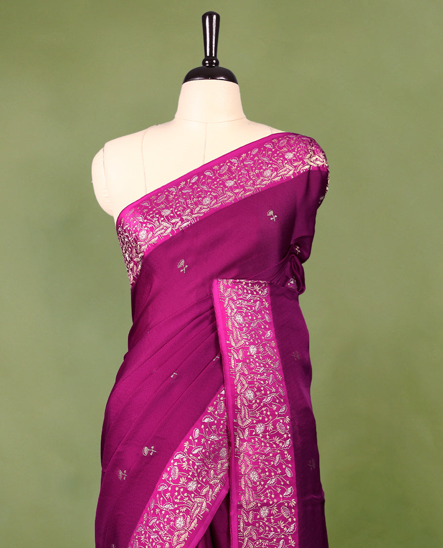 Grape colour pure Banaras crepe saree showcases elegant Gold zari Flower Motifs all over the body, a traditional gold & Silver zari border, a rich intricately woven pallu, and comes with a matching blouse.