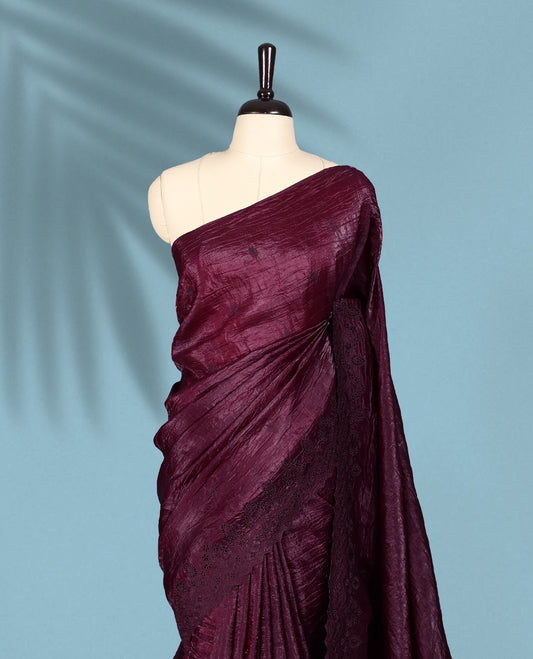 Maroon Colour crush soft silk saree, textured body with a natural crinkled finish, adorned with intricate self colored floral Motifs and complemented by a delicate thread embroidery cutwork border, paired with a matching blouse