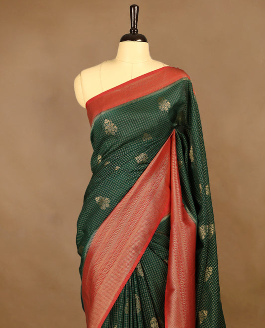 Dark Green Colour semi Banaras georgette saree featuring golden Zari checks with double mango motifs on the body, complemented by a Red traditional border and a matching blouse.