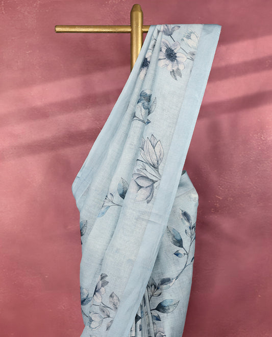 Soothing sky blue colour pure linen saree adorned with delicate floral digital prints across the body, finished with a plain matching border and pairs beautifully with a coordinated blouse.