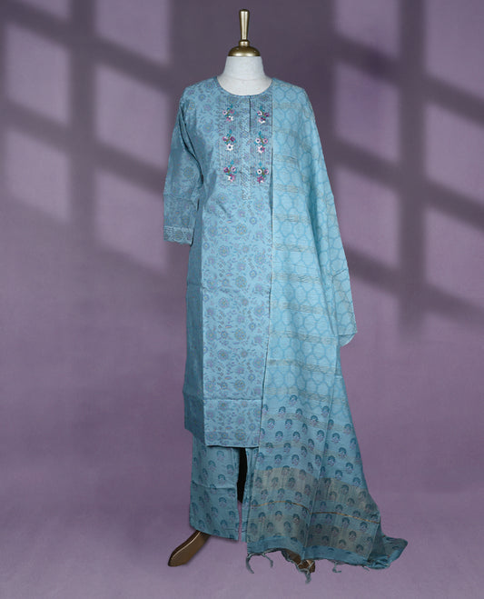 Sky blue colour kurti set features a round neck with delicate embroidery, three-quarter sleeves with subtle detailing, and is paired with matching pants and a tasseled dupatta for a graceful ethnic look.