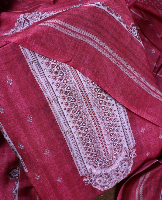 Light maroon colour churidhar material featuring delicate printed patterns with stone highlights, paired with a plain matching bottom and coordinating dupatta.