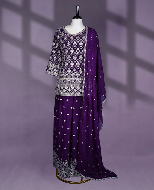 Deep purple Colour sharara set features a V neck and three quarter sleeves, adorned with heavy silver embroidery, Comes with a matching dupatta and an embellished sharara bottom.