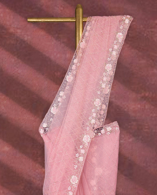 Baby Pink colour net designer saree featuring crisscross cut beads detailing on the body, adorned with beads and sequin worked floral kodi scallop border, paired with a matching worked blouse