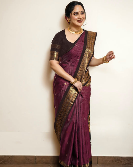 Dark Brown and Dark Pinkish Maroon Colour pure Kancheepuram silk saree featuring gold zari elephant & floral brocade border, body with gold checkered patterns and Gold & Silver colour Peacock Motifs, traditional pallu paired with matching blouse