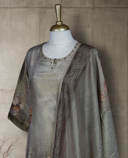 Antique gold colour salwar from TWARA, featuring a delicate embroidered neck with floral thread work & sequin highlights, all over golden and beige style floral on the top, paired with a matching bottom and an elegant dupatta.