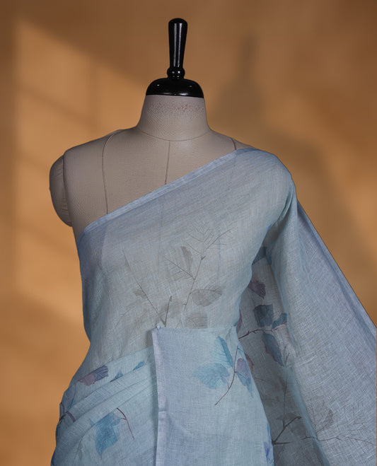 Ice blue colour pure linen saree featuring leaf print pattern across body, silver thin border finished with matching blouse.