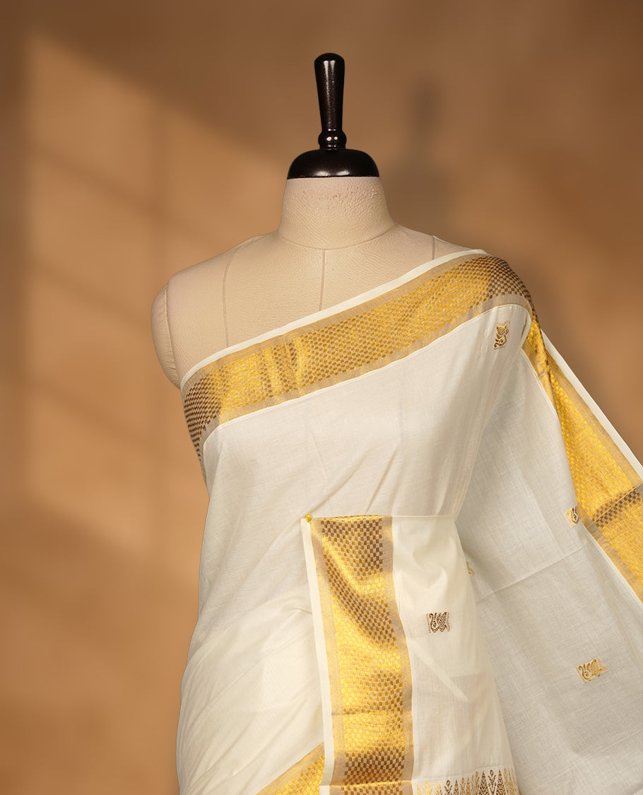 Elegant off white colour cotton Kerala saree with gold zari buttas, broad kasavu border, and richly woven traditional pallu, paired with a matching blouse