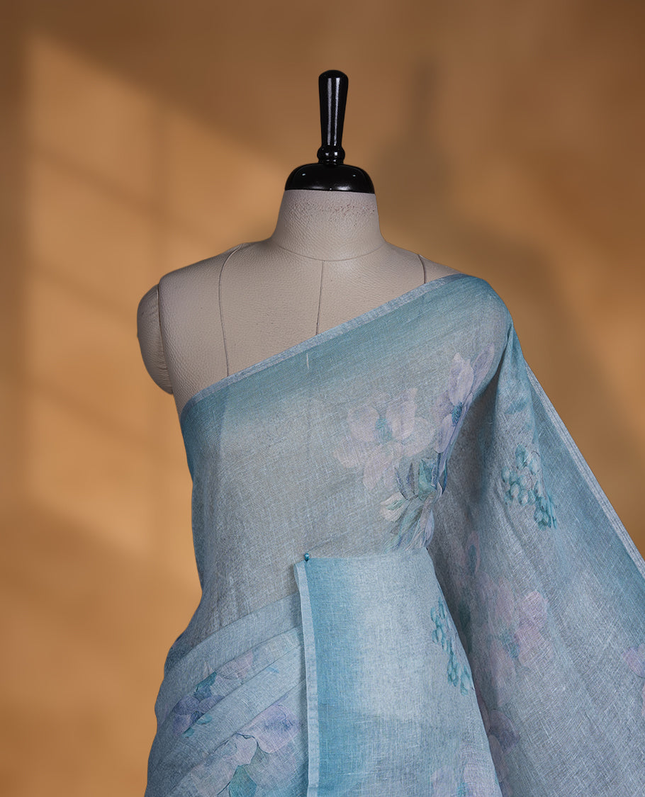 Light blue colour pure linen saree featuring Floral print pattern across body, silver thin border finished with matching blouse.