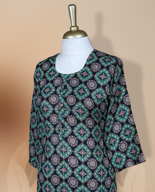 Navy blue colour kurti featuring a round neckline, 3/4th flared sleeves, and an all over geometric floral print in teal and pink hues, designed with a straight cut silhouette for a chic casual look.