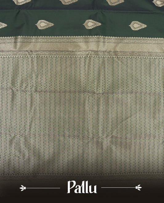 Dark Green colour semi soft silk saree featuring a gold leaf patterned body, complemented by gold traditional pallu & border and a matching blouse piece.