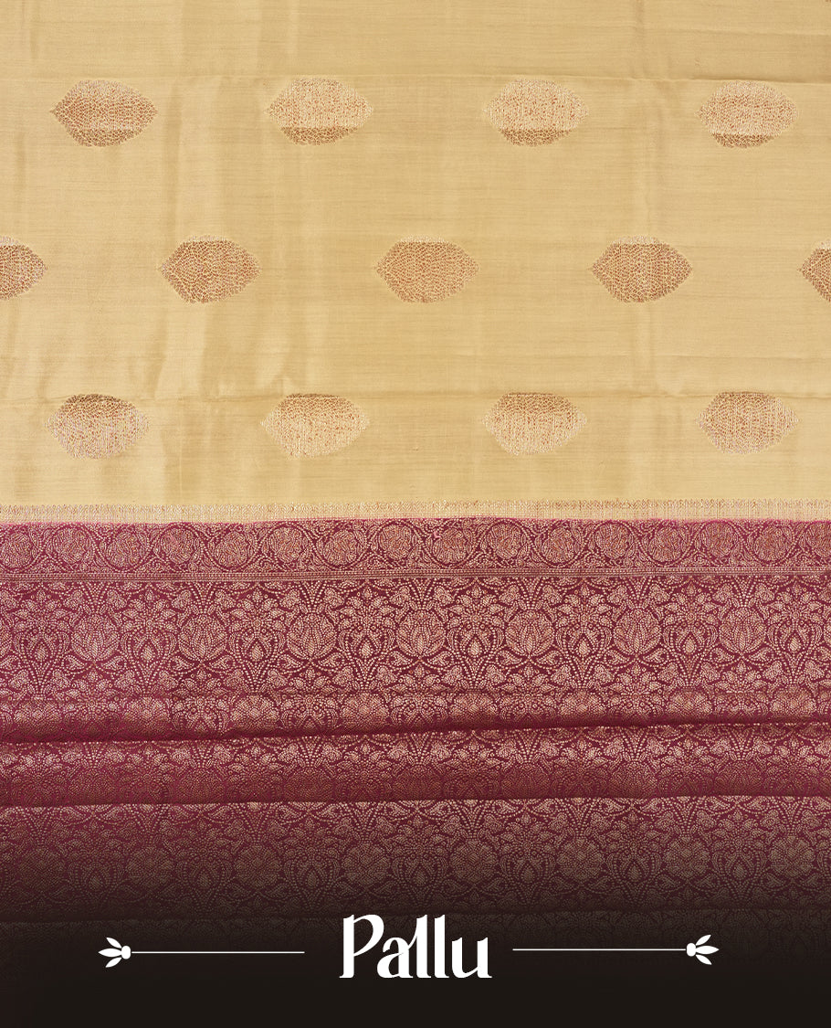 Cream Colour Banaras Soft Silk Saree with Gold Zari Oval Leaf Buttas, Intricate Multi-Layered Floral Border, Grand Pallu with Intricate Brocade Motifs in Deep Maroon and Gold Tones, and Matching Blouse.