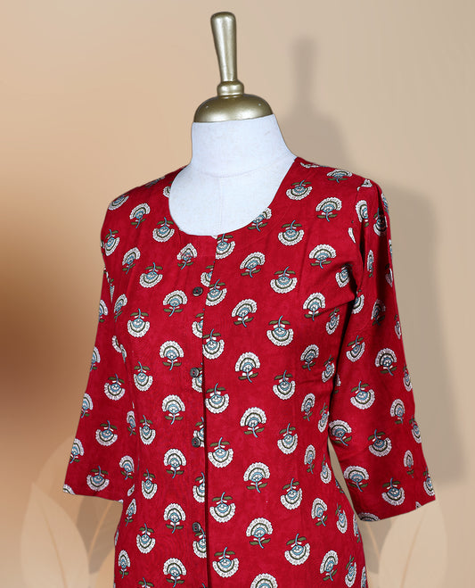 Red kurti featuring a round neckline, 3/4th flared sleeves, and an all over white and teal floral motif print, styled in a straight cut silhouette for a vibrant and elegant casual wear look.