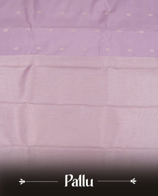 Lavender colour semi soft silk saree featuring a golden textured patterned body, complemented by self coloured golden traditional motifes on pallu & border and a matching blouse piece.