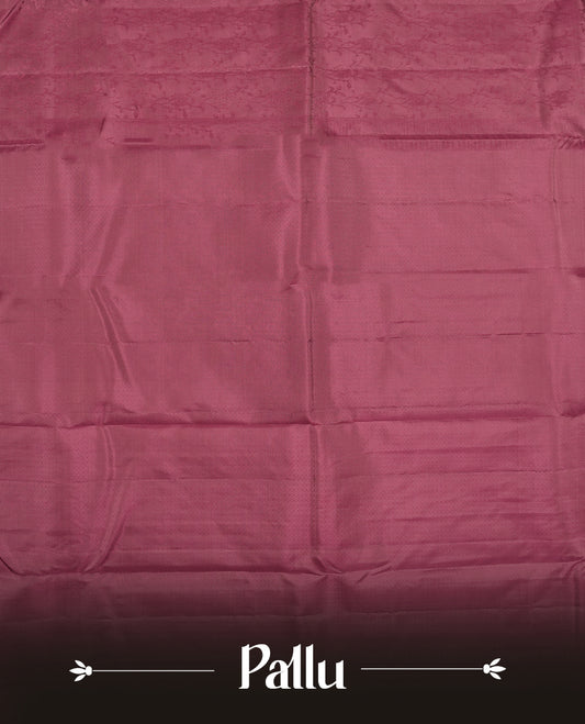 Wine colour semi soft silk saree featuring a self coloured textured patterned body, complemented by self coloured pallu & border and a matching blouse piece.