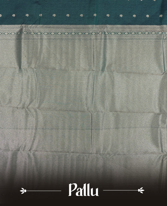 Teal Green colour semi soft silk saree featuring a self coloured textured with golden patterned body, complemented by self coloured golden zari motifes on pallu & border and a matching blouse piece.