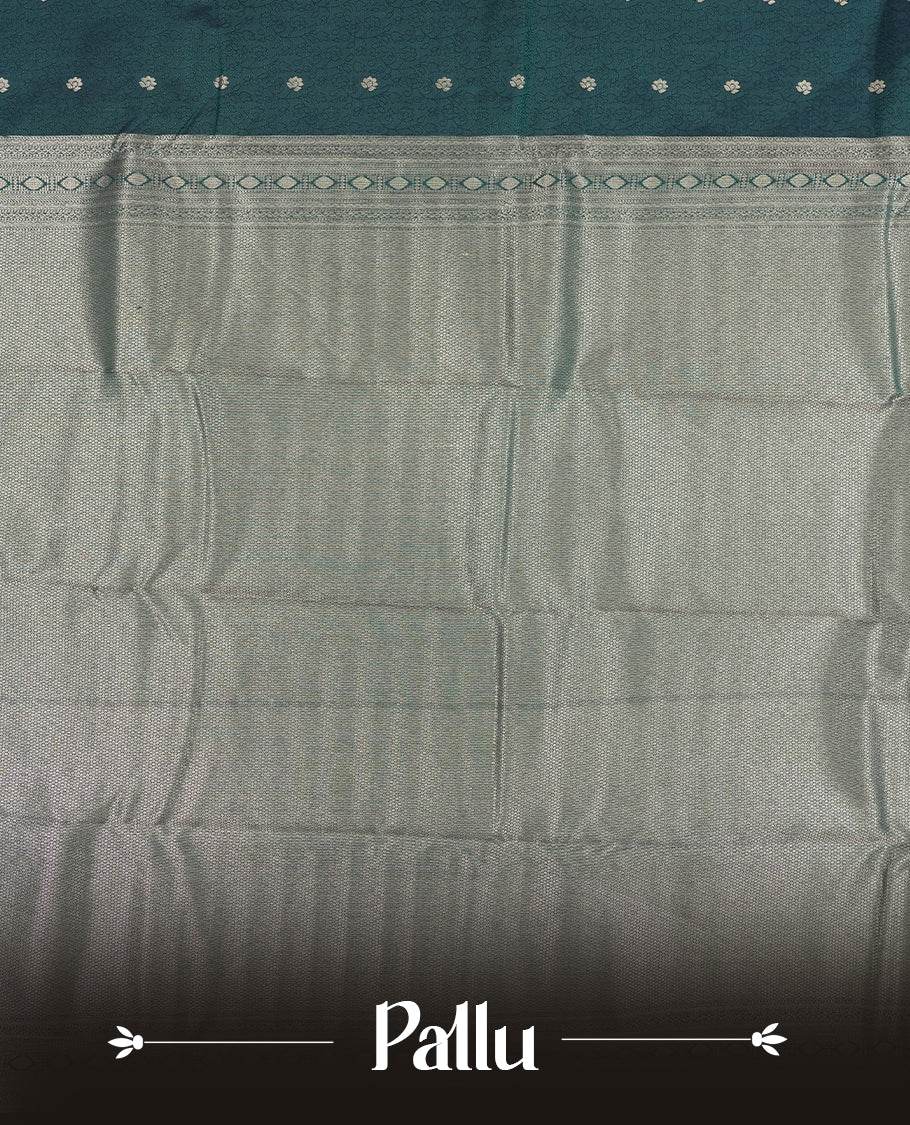 Teal Green colour semi soft silk saree featuring a self coloured textured with golden patterned body, complemented by self coloured golden zari motifes on pallu & border and a matching blouse piece.