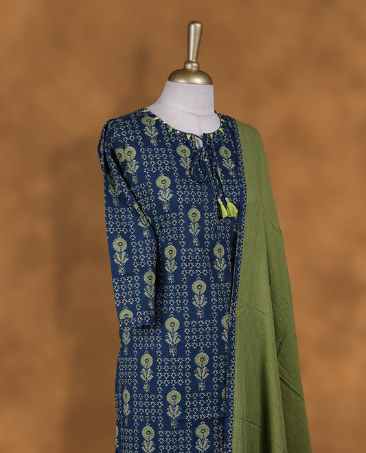 Crystal teal colour churidar set featuring round neckline, three‑fourth sleeves, and all‑over ethnic floral print on body, paired with a contrasting green solid dupatta with printed edging.