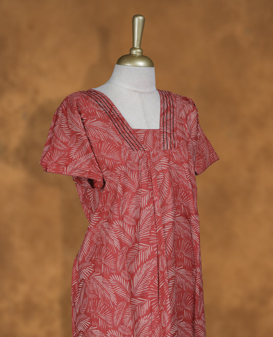 Red colour NStyle nighty featuring cream leaf patterns, a V-neckline with thread detailing, short sleeves, and a full ankle-length design