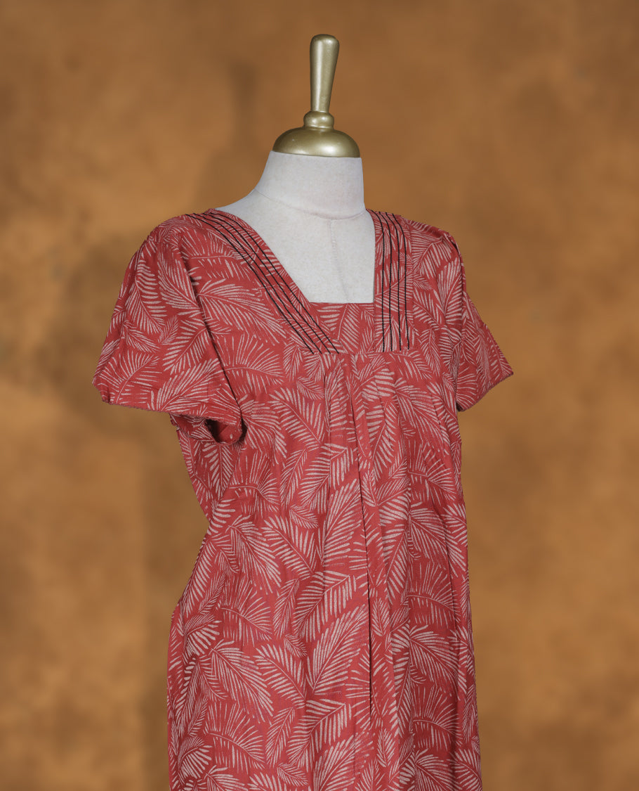 Red colour NStyle nighty featuring cream leaf patterns, a V-neckline with thread detailing, short sleeves, and a full ankle-length design