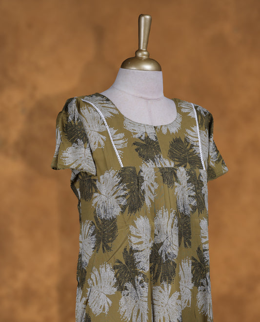 Mustard green colour Nstyle nighty with featuring a White and black leaf pattern, a round neckline with lace detailing, Short sleeve, and a full-length