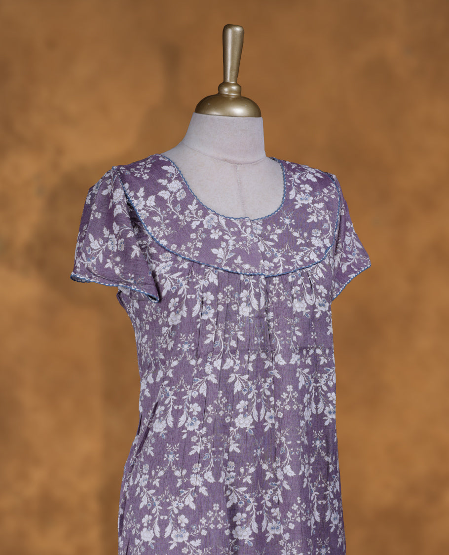 Dusty lavender colour Nstyle nighty with featuring a White floral pattern, a round neckline with lace detailing, Short sleeve, and a full-length