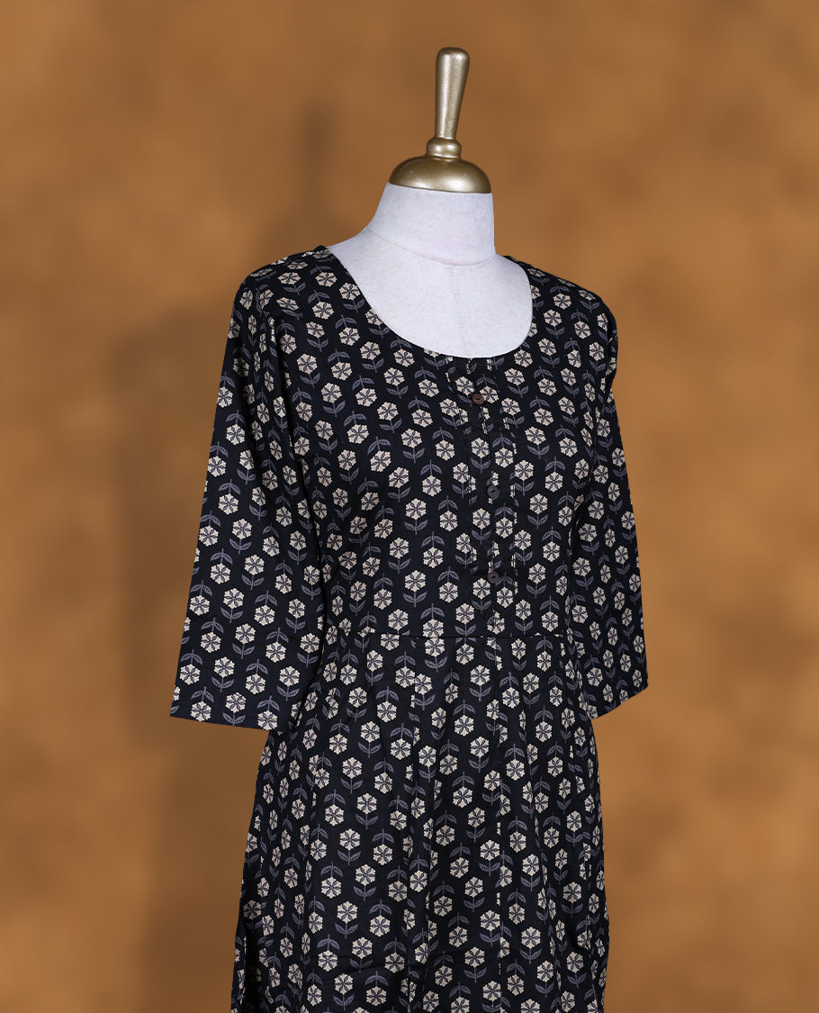 Black colour kurti with styled with a floral print across body, knee length design, and a sleeve .