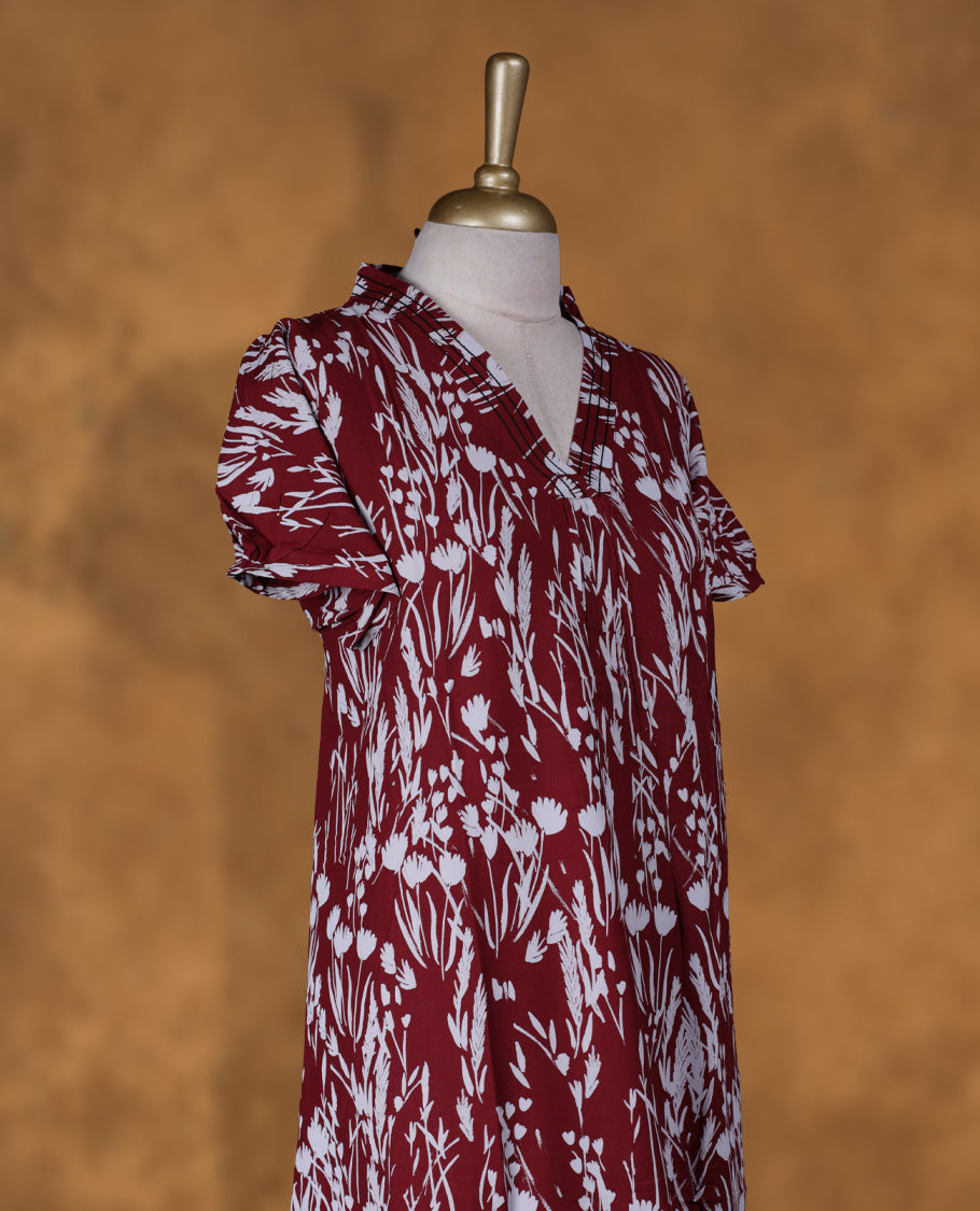 Dark Red colour Nstyle nighty with featuring a White floral pattern, a V neckline with black theard detailing, Short sleeve, and a full-length