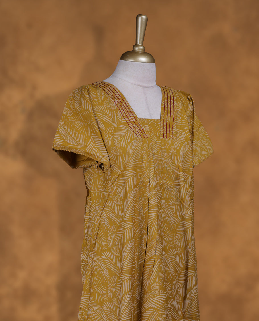 Mustrad colour Nstyle nighty with featuring a cream colour leaf pattern, a V neckline with thrread detailing, short sleeve, and a full-length