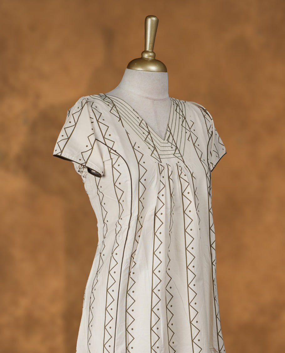 Cream colour NStyle nighty featuring dark green geometric patterns, a V-neckline with thread detailing, short sleeves, and a full ankle-length design.