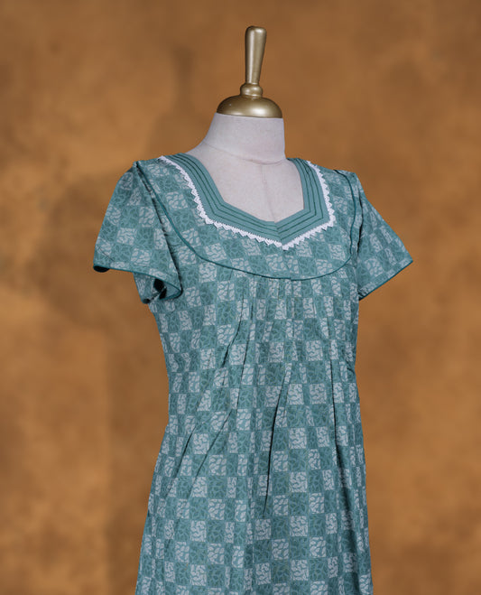 Teal green colour NStyle nighty featuring checkered patterns, a diamond neckline with lace trim detailing, short sleeves, and a full ankle-length design.