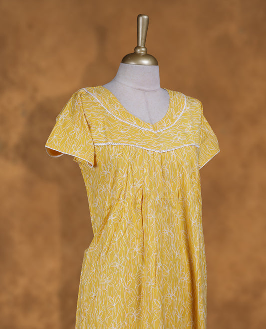 bright Yellow colour NStyle nighty featuring White patterns, a V-neckline with lace detailing, short sleeves, and a full ankle-length design.