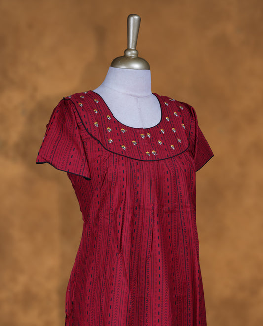 Dark red colour Nstyle nighty with featuring a White floral and black pattern, a V neckline with black lace Border, Short sleeve, and a full-length