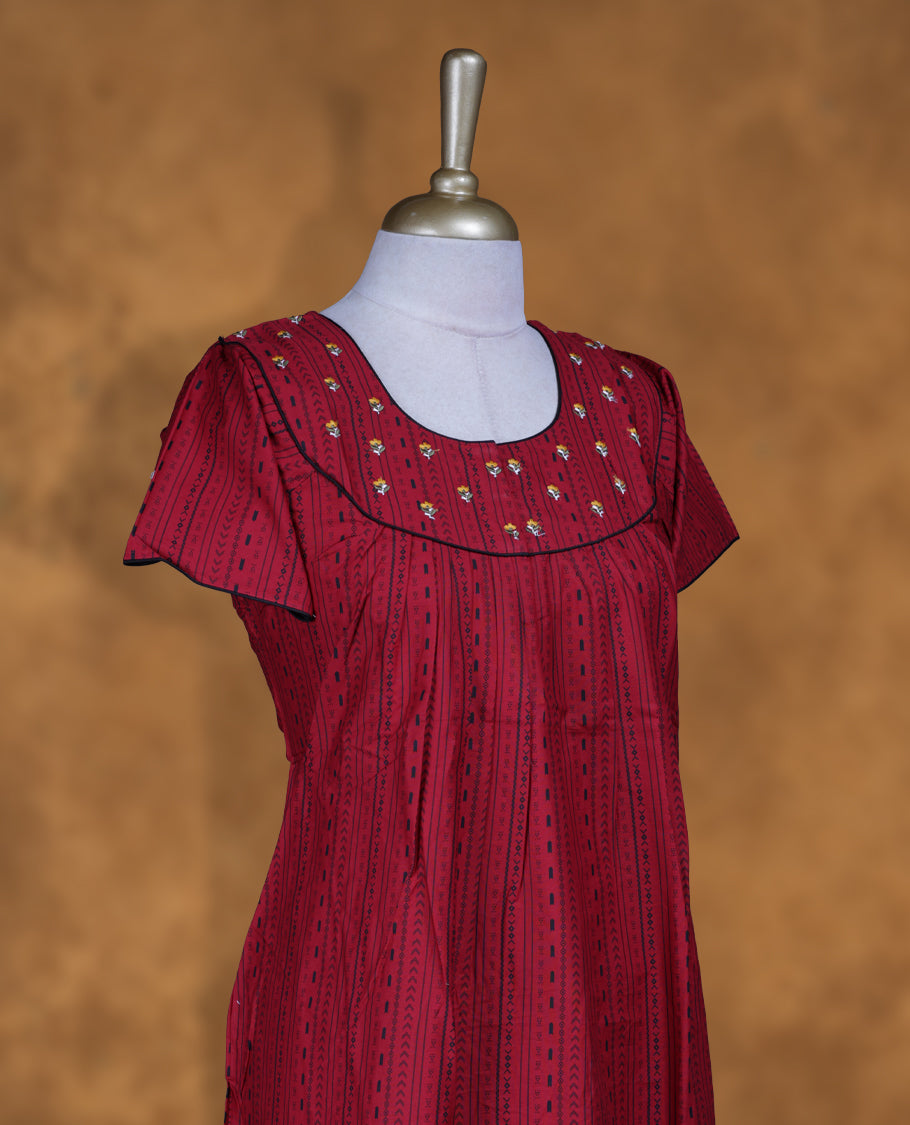 Dark red colour Nstyle nighty with featuring a White floral and black pattern, a V neckline with black lace Border, Short sleeve, and a full-length