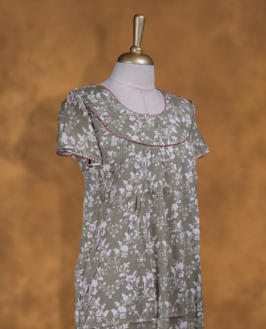 Olive Green colour NStyle nighty featuring white floral patterns, a round neckline with maroon piping detailing, short sleeves, and a full ankle-length design.
