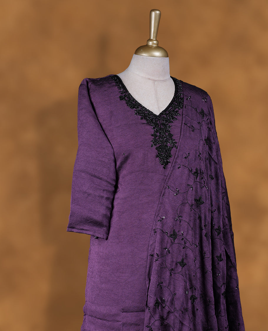 Purple colour churidar set featuring V neckline, three‑fourth sleeves, and tonal bead and thread embellishment along neckline and body, paired with a matching embroidered dupatta.
