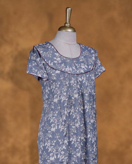 blue gray colour NStyle nighty featuring white floral patterns, a round neckline with maroon piping detailing, short sleeves, and a full ankle-length design.
