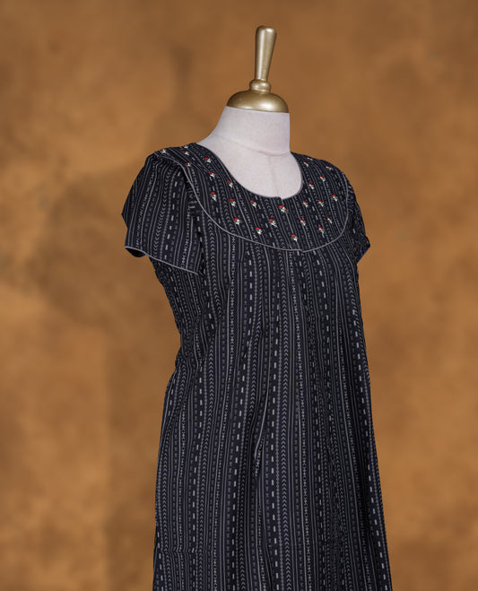 Black colour NStyle nighty featuring gray geometric pattern, coloured floral patterns on a U neckline with gray colour pipe details , short sleeves, and a full ankle-length design.